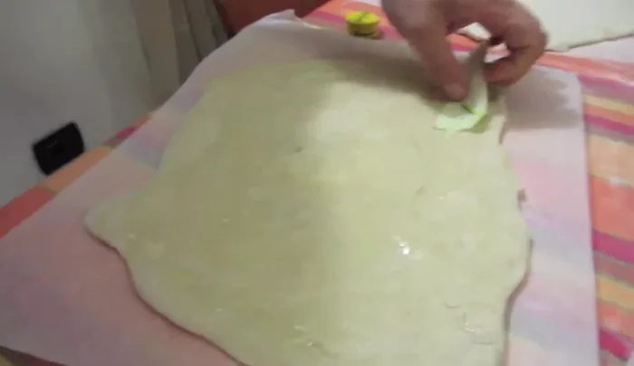 Aggiungete uno strato di zucchine tagliate sottilmente sulla base della pizza.