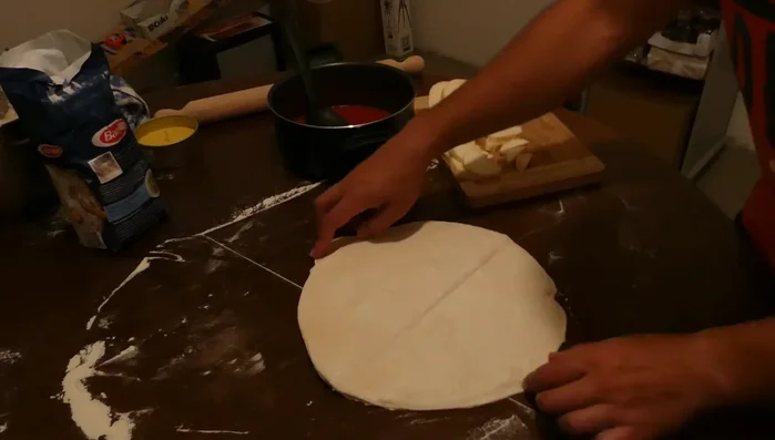 Distribuire uniformemente il sugo sulla pasta della pizza.