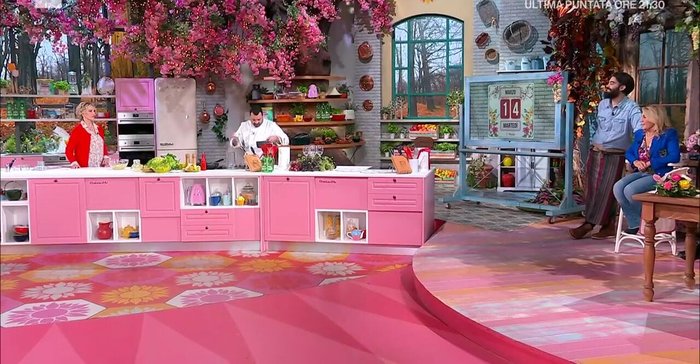 Composizione del piatto: impiattare disponendo il cous cous di cavolfiori, le trecce di spigola, la salsa al vino bianco e il contorno di scarola.