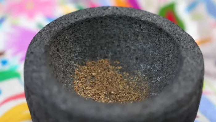 Nel frattempo, preparare gli altri ingredienti: tritare finemente aglio, cipolla e peperoni neri. Aggiungere pimento e cumino.
