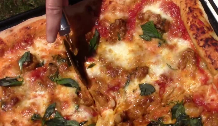 Servire: Una volta cotta, cospargere la pizza con il basilico rimanente e servire.