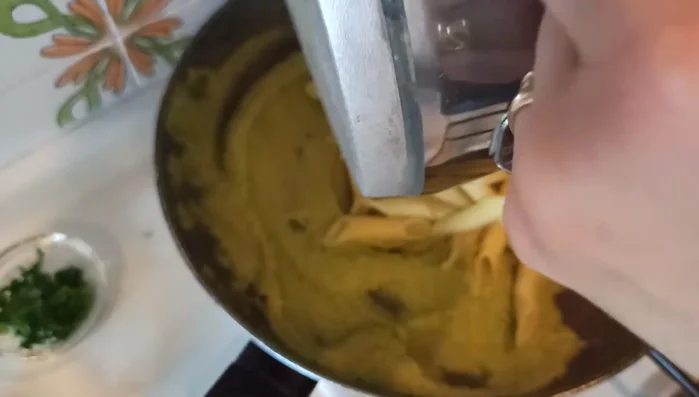 Scolare la pasta e unirla al composto di gamberi e pisellini nella padella.
