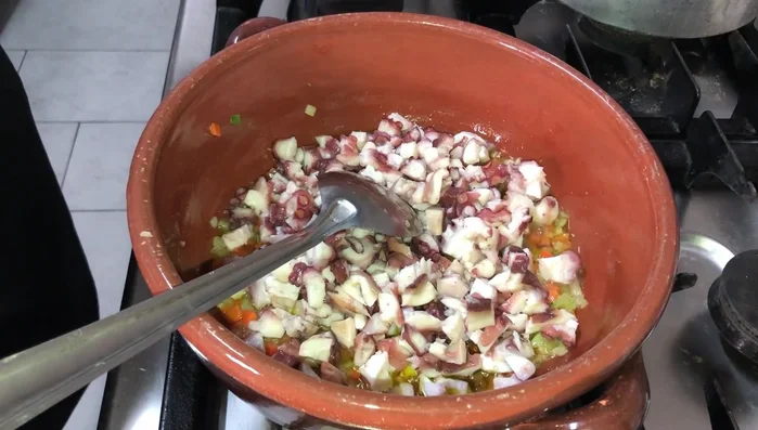 Aggiungere il polpo e farlo soffriggere dolcemente.
