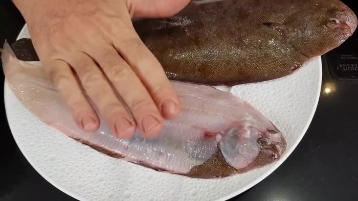 Pulire la sogliola: Rimuovere le viscere e la pelle, creando dei lembi laterali. (Come mostrato nel video)