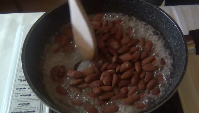 Aggiungere le mandorle tostate al caramello e mescolare bene. Portare la temperatura del caramello a 145°C.