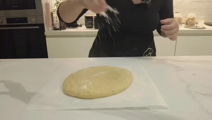 Stendere la pasta frolla su un piano leggermente infarinato, creando un ovale. Lo spessore non deve essere eccessivo.