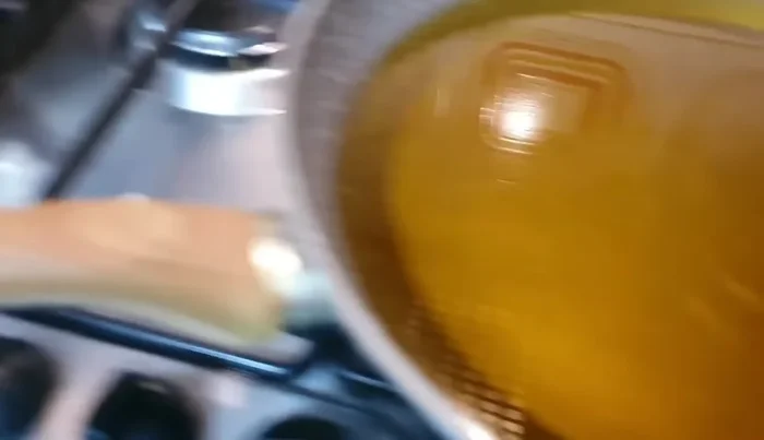 Friggere le melanzane in abbondante olio extravergine d'oliva fino a doratura, poi metterle da parte.