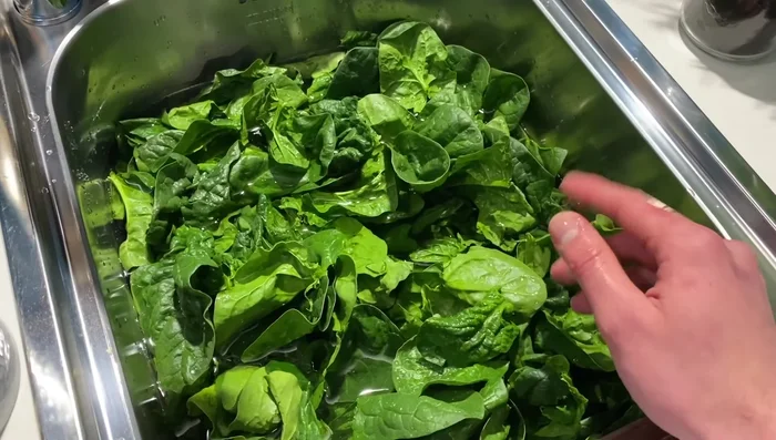 Pulire e cuocere gli spinaci in una padella. Una volta cotti, farli raffreddare per mantenere il colore verde.